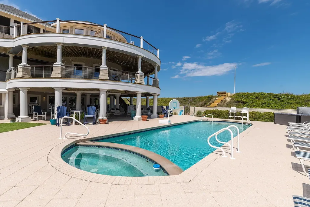 101 Station One Lane Home in Corolla, North Carolina. Discover a remarkable beachfront home with panoramic water views in the prestigious community of Pine Island, Corolla. This stunning coastal retreat offers nine bedrooms with en-suite bathrooms, generous indoor and outdoor amenities, and direct access to 250 feet of secluded beach. 