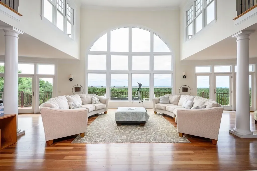 102 Highwood Lane Home in East Falmouth, Massachusetts. Discover unparalleled luxury in Cape Cod's prestigious golf community with this sprawling 10,000-square-foot estate. Perched atop one of Falmouth's highest points, this stunning property offers breathtaking views of Buzzards Bay. Impeccable craftsmanship, elegant design, and high-end finishes define this three-story masterpiece.
