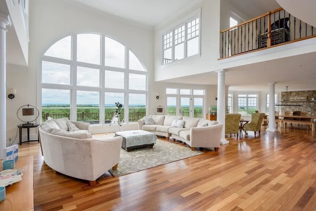 102 Highwood Lane Home in East Falmouth, Massachusetts. Discover unparalleled luxury in Cape Cod's prestigious golf community with this sprawling 10,000-square-foot estate. Perched atop one of Falmouth's highest points, this stunning property offers breathtaking views of Buzzards Bay. Impeccable craftsmanship, elegant design, and high-end finishes define this three-story masterpiece.