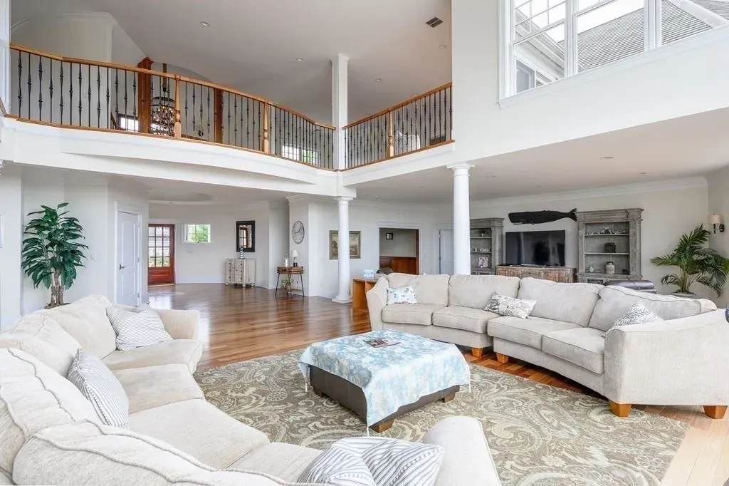 102 Highwood Lane Home in East Falmouth, Massachusetts. Discover unparalleled luxury in Cape Cod's prestigious golf community with this sprawling 10,000-square-foot estate. Perched atop one of Falmouth's highest points, this stunning property offers breathtaking views of Buzzards Bay. Impeccable craftsmanship, elegant design, and high-end finishes define this three-story masterpiece.