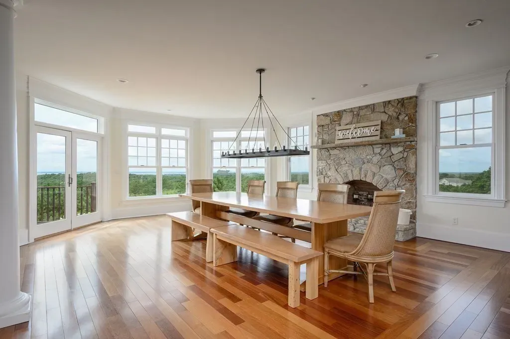 102 Highwood Lane Home in East Falmouth, Massachusetts. Discover unparalleled luxury in Cape Cod's prestigious golf community with this sprawling 10,000-square-foot estate. Perched atop one of Falmouth's highest points, this stunning property offers breathtaking views of Buzzards Bay. Impeccable craftsmanship, elegant design, and high-end finishes define this three-story masterpiece.