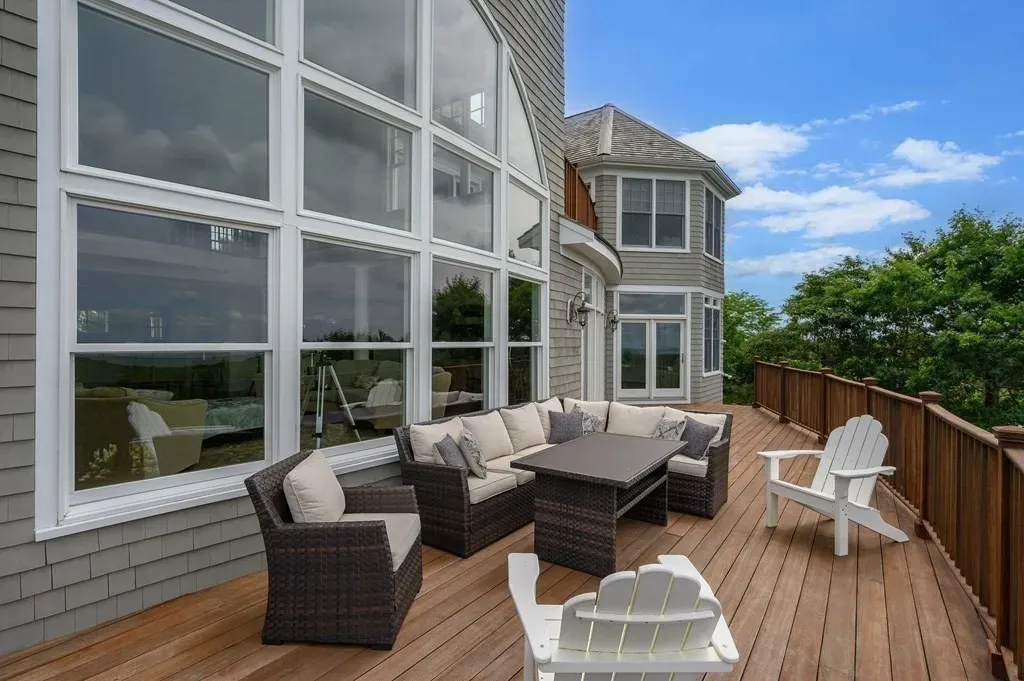 102 Highwood Lane Home in East Falmouth, Massachusetts. Discover unparalleled luxury in Cape Cod's prestigious golf community with this sprawling 10,000-square-foot estate. Perched atop one of Falmouth's highest points, this stunning property offers breathtaking views of Buzzards Bay. Impeccable craftsmanship, elegant design, and high-end finishes define this three-story masterpiece.