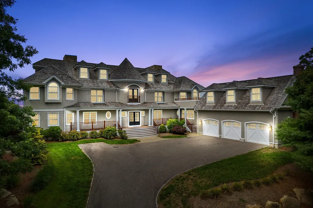 102 Highwood Lane Home in East Falmouth, Massachusetts. Discover unparalleled luxury in Cape Cod's prestigious golf community with this sprawling 10,000-square-foot estate. Perched atop one of Falmouth's highest points, this stunning property offers breathtaking views of Buzzards Bay. Impeccable craftsmanship, elegant design, and high-end finishes define this three-story masterpiece.