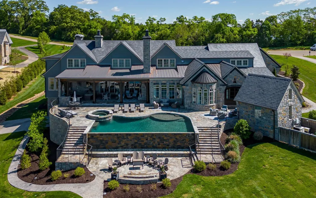10416 Leonidas Meadow Way Home in Knoxville, Tennessee. Experience the epitome of lakeside luxury in the prestigious West Knoxville enclave of Arcadia. Nestled within this exclusive community, this opulent estate stretches across more than 2.5 acres of prime lakefront property, offering an astonishing 13,000 square feet of meticulously crafted living space. With custom millwork and intricate stonework adorning every corner, this slate and stone residence was artfully constructed with lavishness in mind.