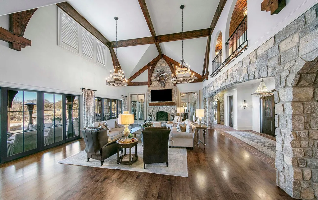 10416 Leonidas Meadow Way Home in Knoxville, Tennessee. Experience the epitome of lakeside luxury in the prestigious West Knoxville enclave of Arcadia. Nestled within this exclusive community, this opulent estate stretches across more than 2.5 acres of prime lakefront property, offering an astonishing 13,000 square feet of meticulously crafted living space. With custom millwork and intricate stonework adorning every corner, this slate and stone residence was artfully constructed with lavishness in mind.