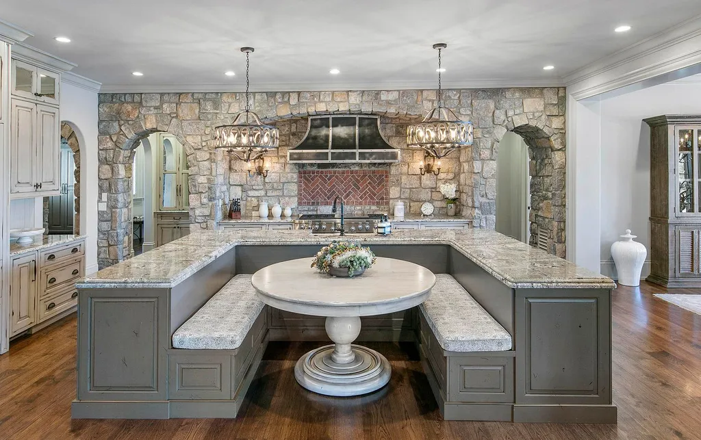 10416 Leonidas Meadow Way Home in Knoxville, Tennessee. Experience the epitome of lakeside luxury in the prestigious West Knoxville enclave of Arcadia. Nestled within this exclusive community, this opulent estate stretches across more than 2.5 acres of prime lakefront property, offering an astonishing 13,000 square feet of meticulously crafted living space. With custom millwork and intricate stonework adorning every corner, this slate and stone residence was artfully constructed with lavishness in mind.