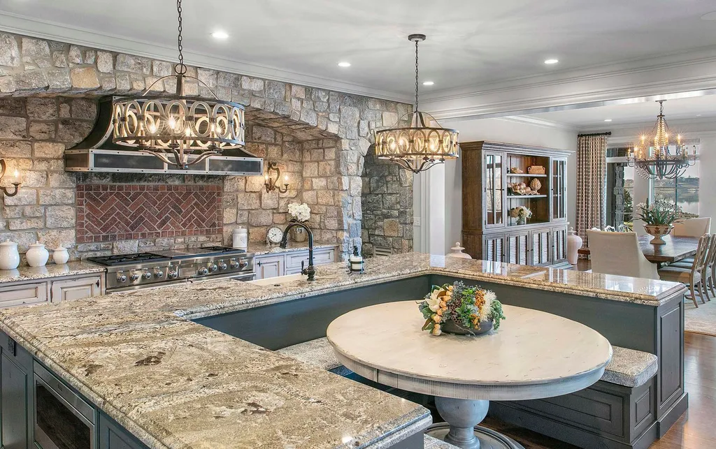 10416 Leonidas Meadow Way Home in Knoxville, Tennessee. Experience the epitome of lakeside luxury in the prestigious West Knoxville enclave of Arcadia. Nestled within this exclusive community, this opulent estate stretches across more than 2.5 acres of prime lakefront property, offering an astonishing 13,000 square feet of meticulously crafted living space. With custom millwork and intricate stonework adorning every corner, this slate and stone residence was artfully constructed with lavishness in mind.
