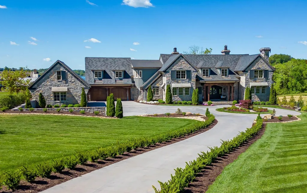 10416 Leonidas Meadow Way Home in Knoxville, Tennessee. Experience the epitome of lakeside luxury in the prestigious West Knoxville enclave of Arcadia. Nestled within this exclusive community, this opulent estate stretches across more than 2.5 acres of prime lakefront property, offering an astonishing 13,000 square feet of meticulously crafted living space. With custom millwork and intricate stonework adorning every corner, this slate and stone residence was artfully constructed with lavishness in mind.