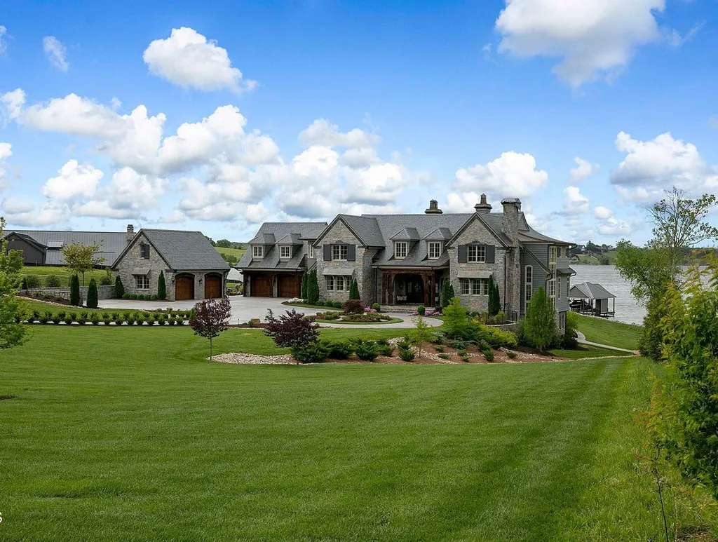 10416 Leonidas Meadow Way Home in Knoxville, Tennessee. Experience the epitome of lakeside luxury in the prestigious West Knoxville enclave of Arcadia. Nestled within this exclusive community, this opulent estate stretches across more than 2.5 acres of prime lakefront property, offering an astonishing 13,000 square feet of meticulously crafted living space. With custom millwork and intricate stonework adorning every corner, this slate and stone residence was artfully constructed with lavishness in mind.