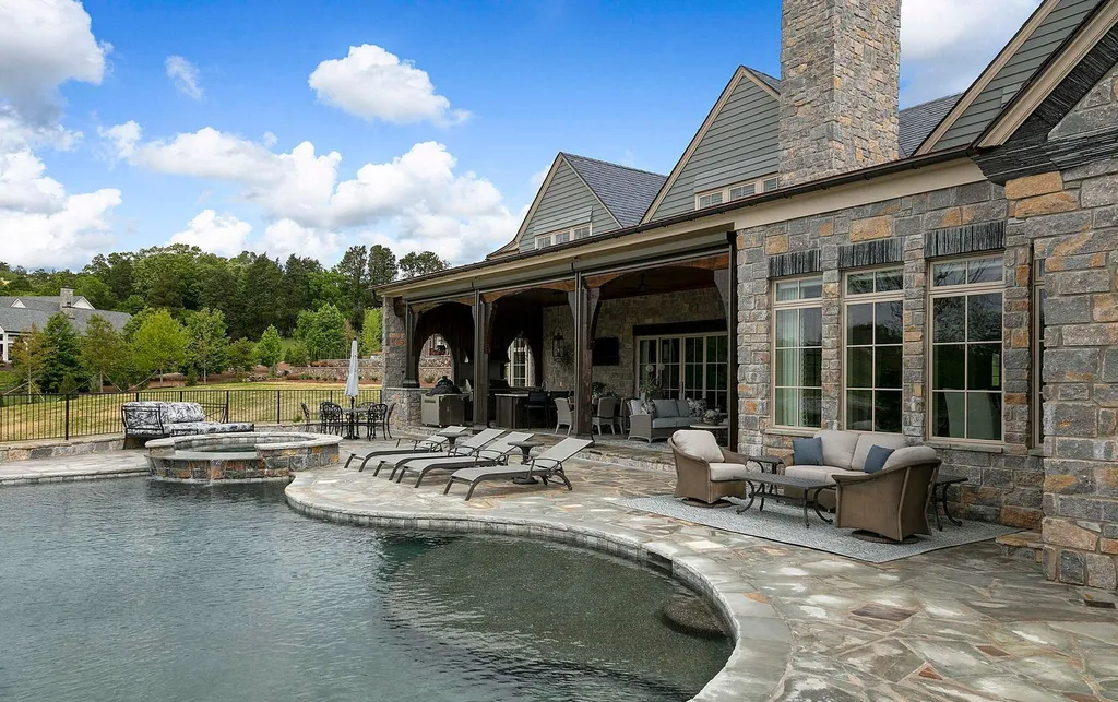 10416 Leonidas Meadow Way Home in Knoxville, Tennessee. Experience the epitome of lakeside luxury in the prestigious West Knoxville enclave of Arcadia. Nestled within this exclusive community, this opulent estate stretches across more than 2.5 acres of prime lakefront property, offering an astonishing 13,000 square feet of meticulously crafted living space. With custom millwork and intricate stonework adorning every corner, this slate and stone residence was artfully constructed with lavishness in mind.