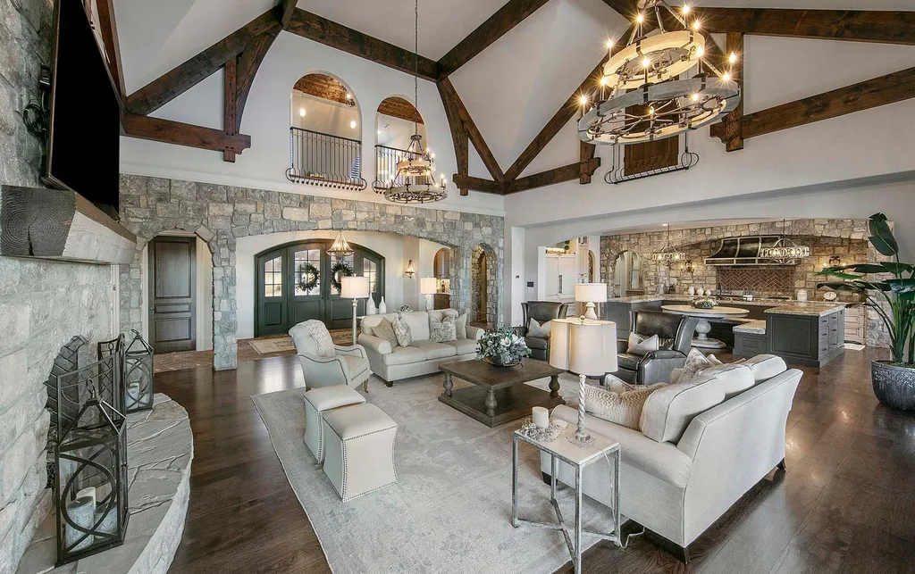 10416 Leonidas Meadow Way Home in Knoxville, Tennessee. Experience the epitome of lakeside luxury in the prestigious West Knoxville enclave of Arcadia. Nestled within this exclusive community, this opulent estate stretches across more than 2.5 acres of prime lakefront property, offering an astonishing 13,000 square feet of meticulously crafted living space. With custom millwork and intricate stonework adorning every corner, this slate and stone residence was artfully constructed with lavishness in mind.