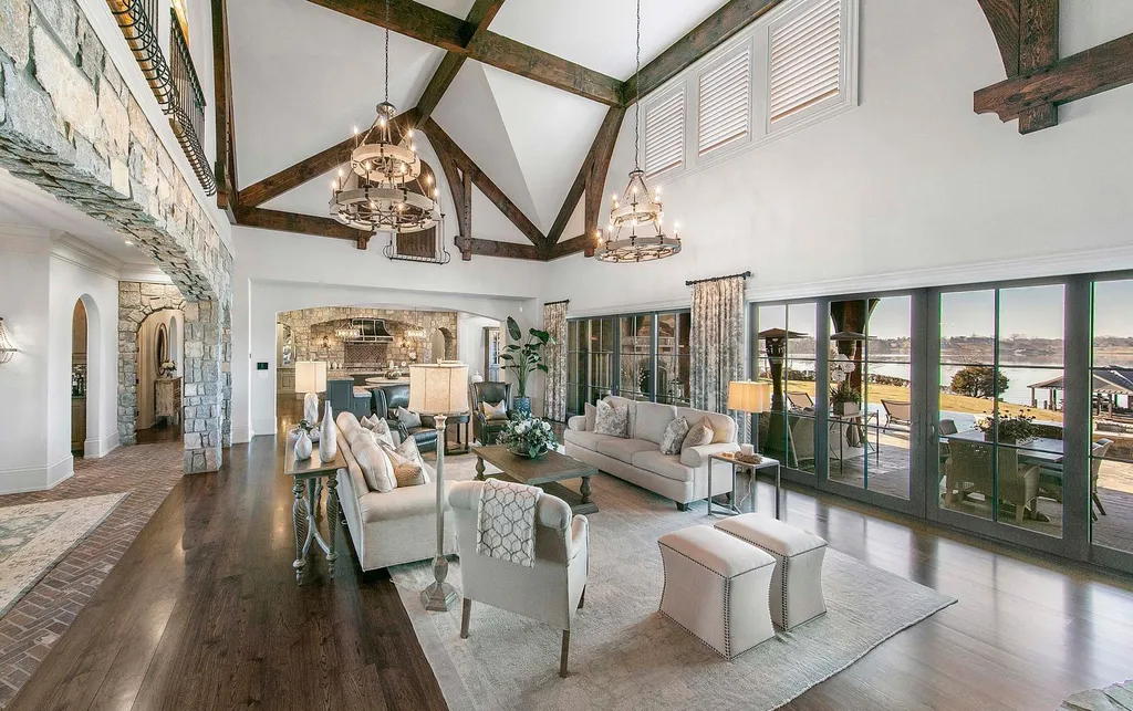 10416 Leonidas Meadow Way Home in Knoxville, Tennessee. Experience the epitome of lakeside luxury in the prestigious West Knoxville enclave of Arcadia. Nestled within this exclusive community, this opulent estate stretches across more than 2.5 acres of prime lakefront property, offering an astonishing 13,000 square feet of meticulously crafted living space. With custom millwork and intricate stonework adorning every corner, this slate and stone residence was artfully constructed with lavishness in mind.