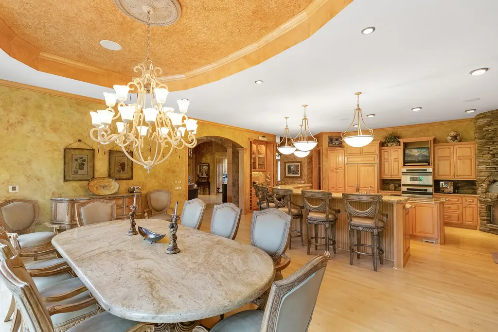 11343 Entrevaux Drive Home in Eden Prairie, Minnesota. Discover the epitome of luxury living in this custom-built Wooddale home, nestled on a serene lot with an extraordinary backyard oasis. The resort-style concrete pool, hot tub, waterfalls, expansive deck, and pergola with a fireplace create an entertainer's dream.