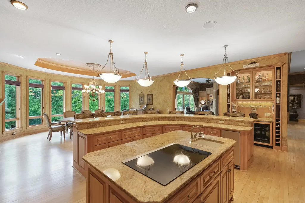 11343 Entrevaux Drive Home in Eden Prairie, Minnesota. Discover the epitome of luxury living in this custom-built Wooddale home, nestled on a serene lot with an extraordinary backyard oasis. The resort-style concrete pool, hot tub, waterfalls, expansive deck, and pergola with a fireplace create an entertainer's dream.