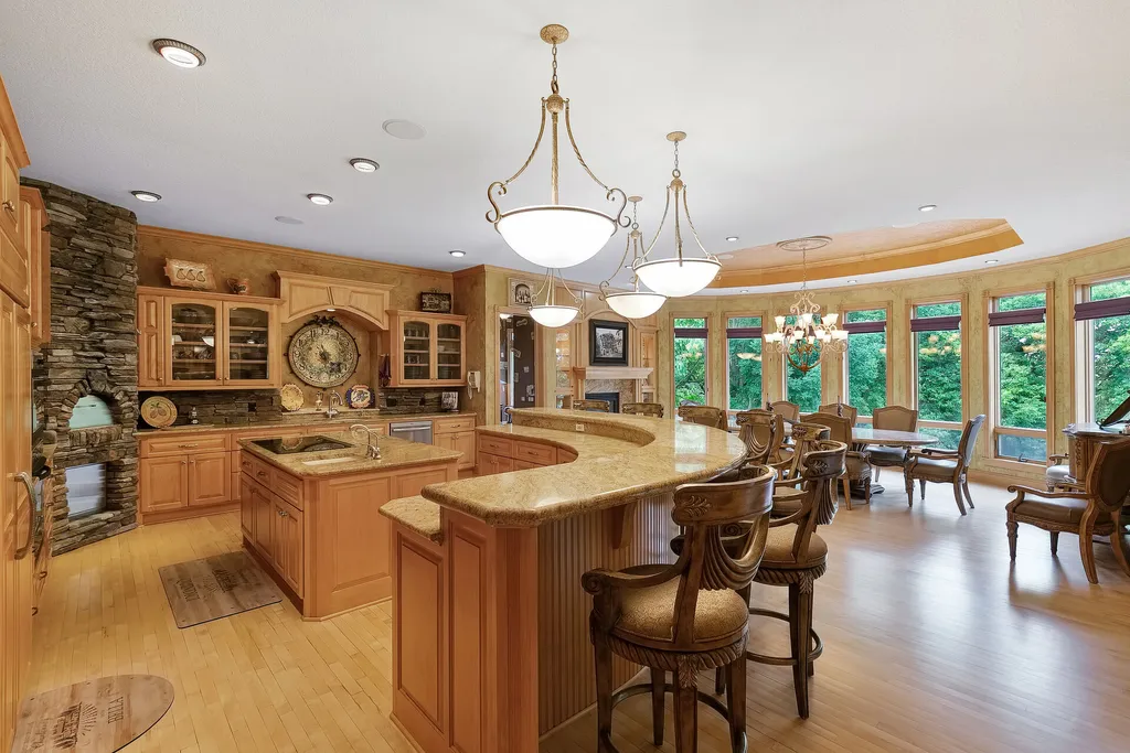11343 Entrevaux Drive Home in Eden Prairie, Minnesota. Discover the epitome of luxury living in this custom-built Wooddale home, nestled on a serene lot with an extraordinary backyard oasis. The resort-style concrete pool, hot tub, waterfalls, expansive deck, and pergola with a fireplace create an entertainer's dream.