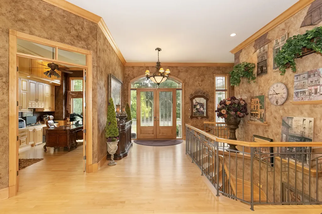 11343 Entrevaux Drive Home in Eden Prairie, Minnesota. Discover the epitome of luxury living in this custom-built Wooddale home, nestled on a serene lot with an extraordinary backyard oasis. The resort-style concrete pool, hot tub, waterfalls, expansive deck, and pergola with a fireplace create an entertainer's dream.