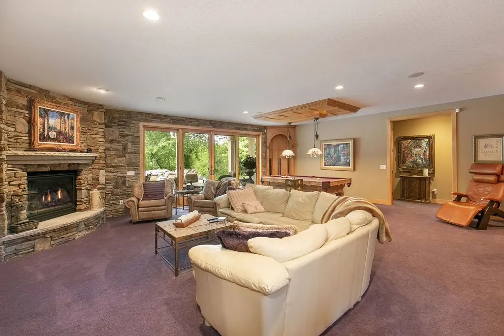 11343 Entrevaux Drive Home in Eden Prairie, Minnesota. Discover the epitome of luxury living in this custom-built Wooddale home, nestled on a serene lot with an extraordinary backyard oasis. The resort-style concrete pool, hot tub, waterfalls, expansive deck, and pergola with a fireplace create an entertainer's dream.