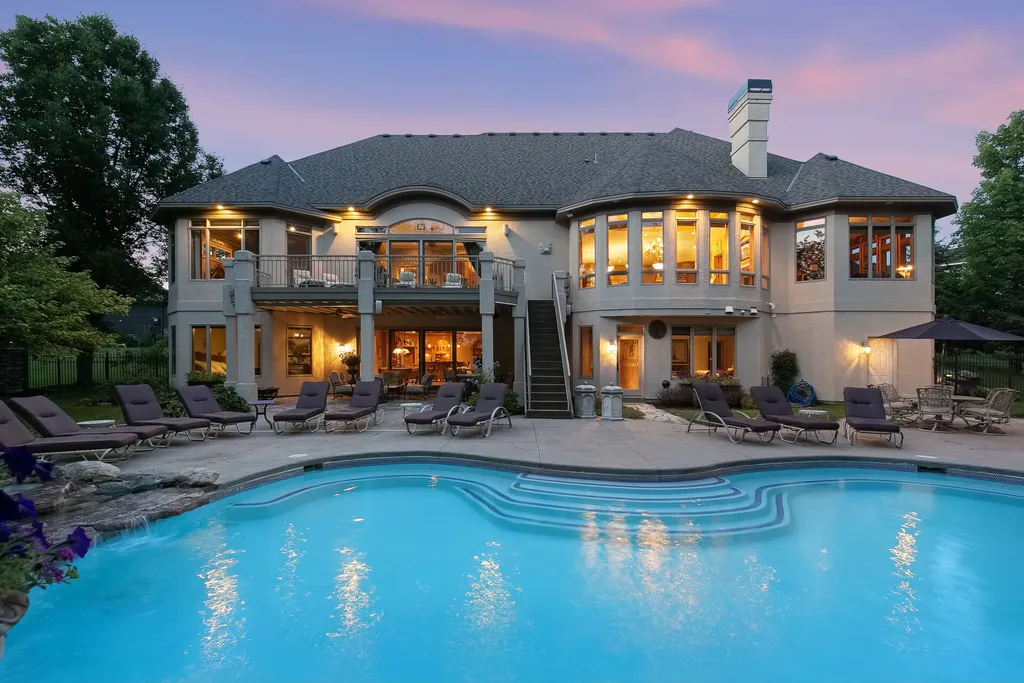 11343 Entrevaux Drive Home in Eden Prairie, Minnesota. Discover the epitome of luxury living in this custom-built Wooddale home, nestled on a serene lot with an extraordinary backyard oasis. The resort-style concrete pool, hot tub, waterfalls, expansive deck, and pergola with a fireplace create an entertainer's dream.