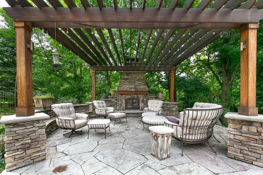 11343 Entrevaux Drive Home in Eden Prairie, Minnesota. Discover the epitome of luxury living in this custom-built Wooddale home, nestled on a serene lot with an extraordinary backyard oasis. The resort-style concrete pool, hot tub, waterfalls, expansive deck, and pergola with a fireplace create an entertainer's dream.