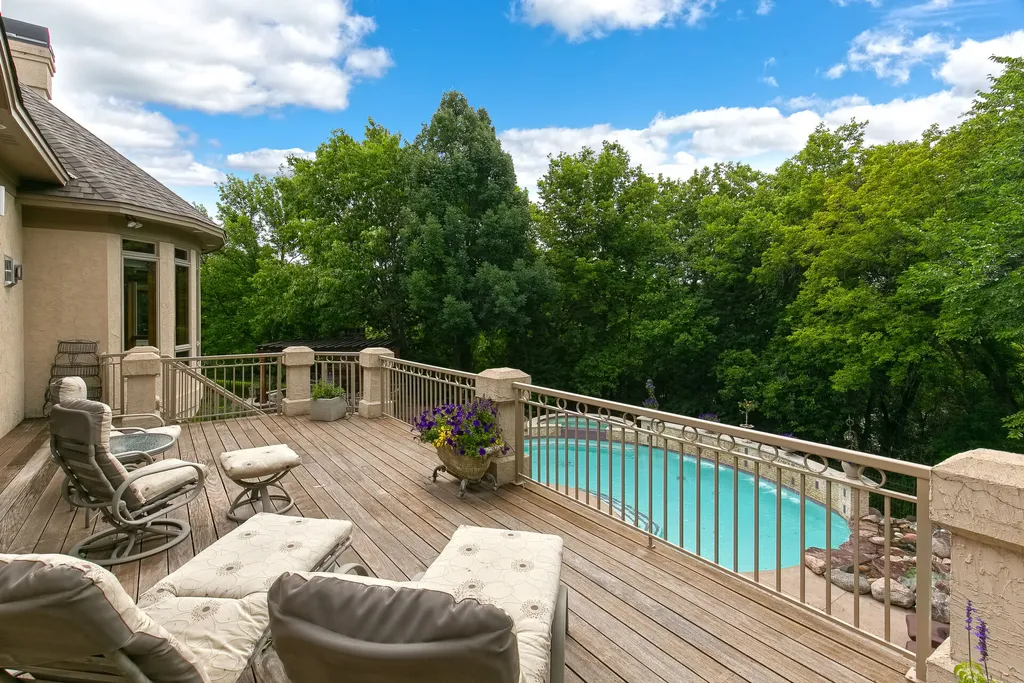 11343 Entrevaux Drive Home in Eden Prairie, Minnesota. Discover the epitome of luxury living in this custom-built Wooddale home, nestled on a serene lot with an extraordinary backyard oasis. The resort-style concrete pool, hot tub, waterfalls, expansive deck, and pergola with a fireplace create an entertainer's dream.