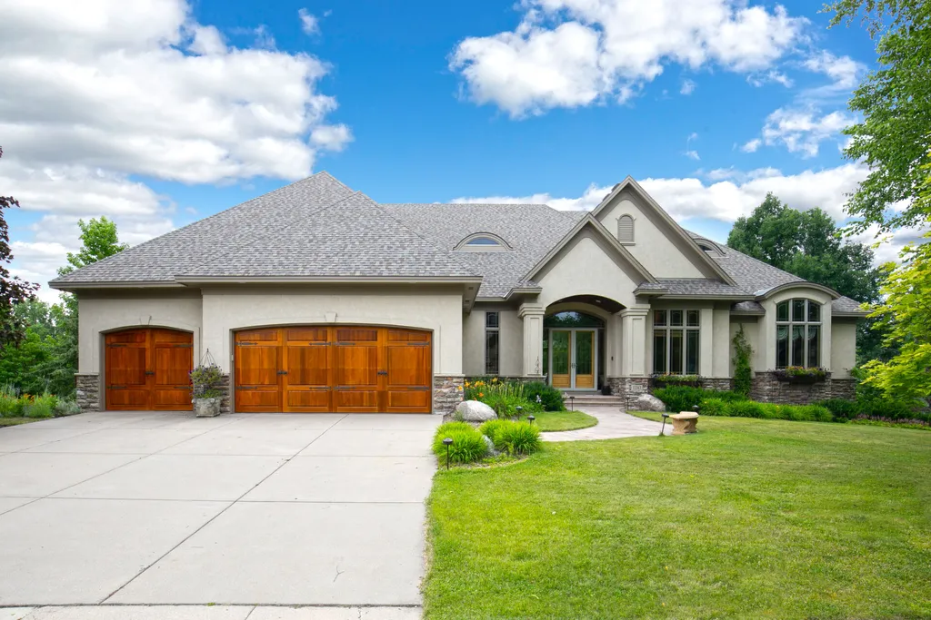 11343 Entrevaux Drive Home in Eden Prairie, Minnesota. Discover the epitome of luxury living in this custom-built Wooddale home, nestled on a serene lot with an extraordinary backyard oasis. The resort-style concrete pool, hot tub, waterfalls, expansive deck, and pergola with a fireplace create an entertainer's dream.