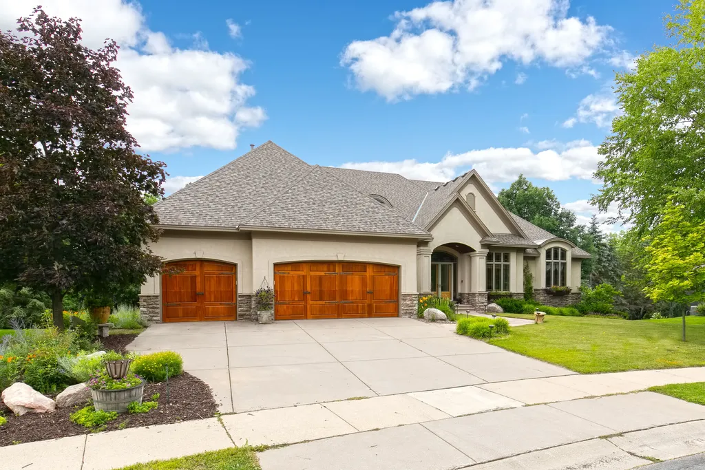 11343 Entrevaux Drive Home in Eden Prairie, Minnesota. Discover the epitome of luxury living in this custom-built Wooddale home, nestled on a serene lot with an extraordinary backyard oasis. The resort-style concrete pool, hot tub, waterfalls, expansive deck, and pergola with a fireplace create an entertainer's dream.
