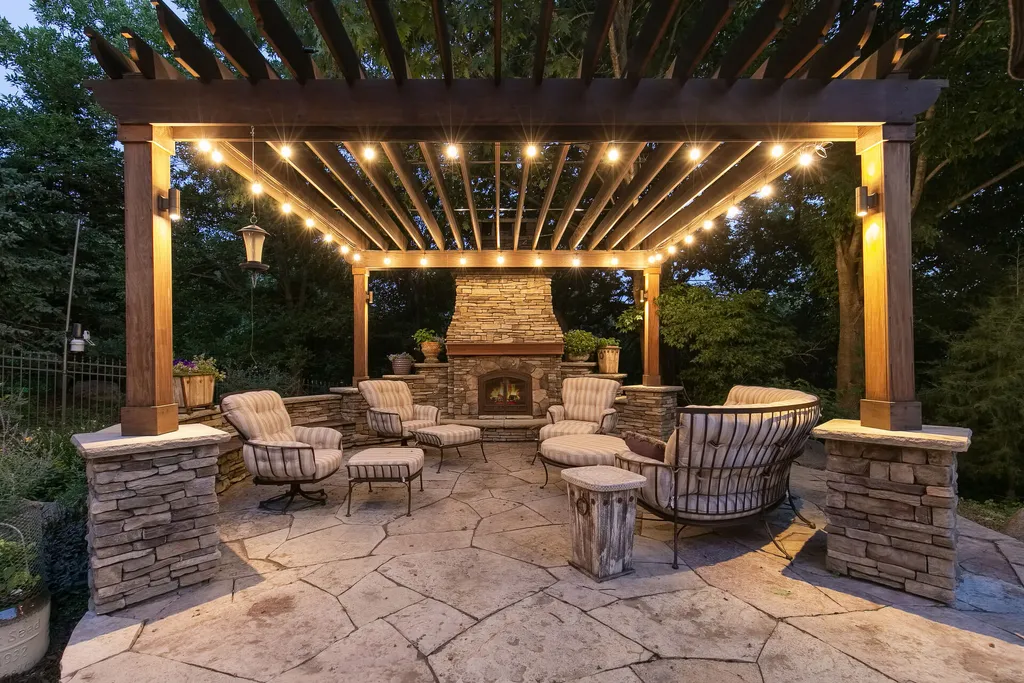 11343 Entrevaux Drive Home in Eden Prairie, Minnesota. Discover the epitome of luxury living in this custom-built Wooddale home, nestled on a serene lot with an extraordinary backyard oasis. The resort-style concrete pool, hot tub, waterfalls, expansive deck, and pergola with a fireplace create an entertainer's dream.