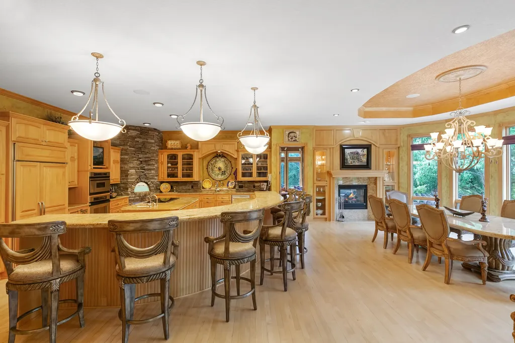 11343 Entrevaux Drive Home in Eden Prairie, Minnesota. Discover the epitome of luxury living in this custom-built Wooddale home, nestled on a serene lot with an extraordinary backyard oasis. The resort-style concrete pool, hot tub, waterfalls, expansive deck, and pergola with a fireplace create an entertainer's dream.