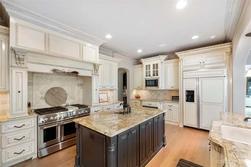 12144 James Jack Lane Home in Charlotte, North Carolina. Discover the epitome of luxury living in this stunning estate nestled on a private cul-de-sac lot with breathtaking views of the 12th and 13th holes of Ballantyne Country Club's finest golf course. 