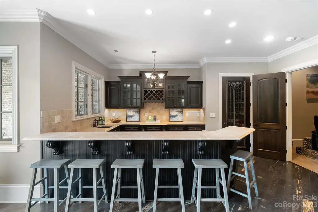 12144 James Jack Lane Home in Charlotte, North Carolina. Discover the epitome of luxury living in this stunning estate nestled on a private cul-de-sac lot with breathtaking views of the 12th and 13th holes of Ballantyne Country Club's finest golf course. 