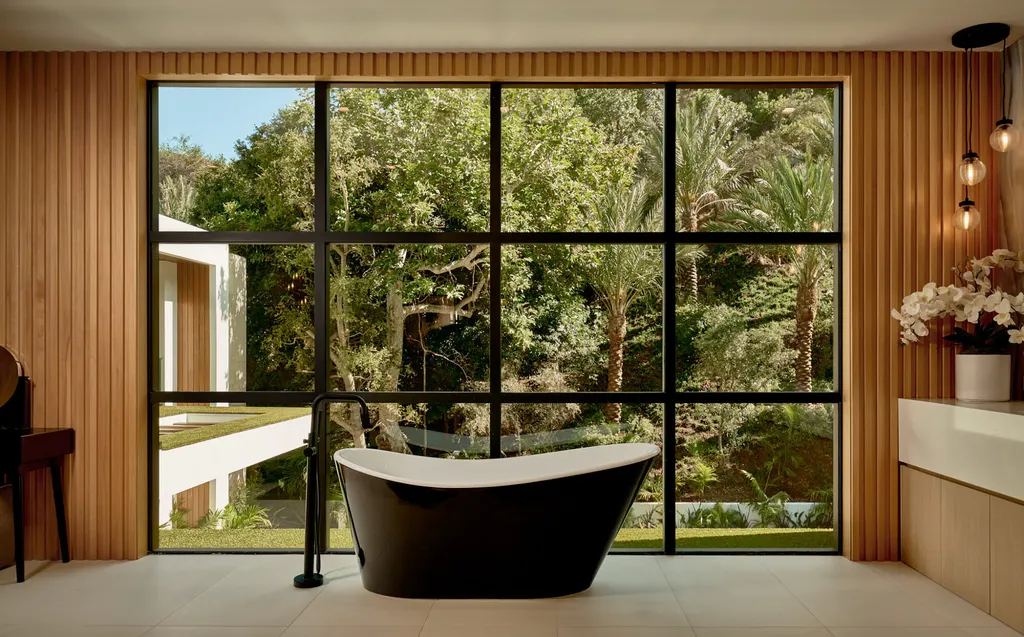 13187 Chalon Road Home in Los Angeles, California. Embrace the epitome of modern luxury living at Allure, a stunning estate designed by award-winning Developer Ramtin Ray Nosrati. Set on 1.3 acres of picturesque California landscape, this idyllic paradise offers resort-quality amenities including a pickleball court, a professional-size basketball/sports court, putting green, and more. 