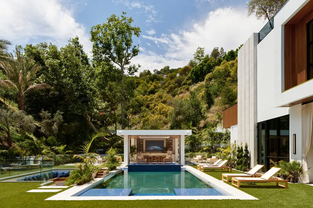 13187 Chalon Road Home in Los Angeles, California. Embrace the epitome of modern luxury living at Allure, a stunning estate designed by award-winning Developer Ramtin Ray Nosrati. Set on 1.3 acres of picturesque California landscape, this idyllic paradise offers resort-quality amenities including a pickleball court, a professional-size basketball/sports court, putting green, and more. 