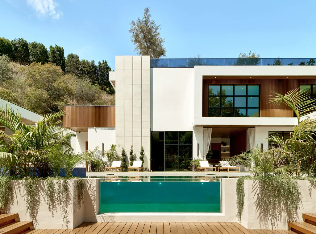 13187 Chalon Road Home in Los Angeles, California. Embrace the epitome of modern luxury living at Allure, a stunning estate designed by award-winning Developer Ramtin Ray Nosrati. Set on 1.3 acres of picturesque California landscape, this idyllic paradise offers resort-quality amenities including a pickleball court, a professional-size basketball/sports court, putting green, and more. 