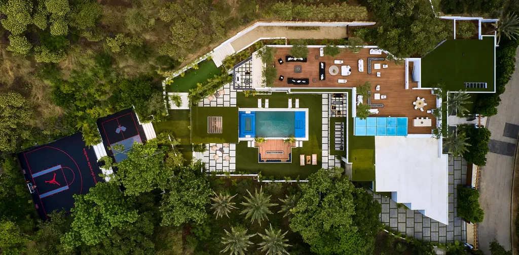 13187 Chalon Road Home in Los Angeles, California. Embrace the epitome of modern luxury living at Allure, a stunning estate designed by award-winning Developer Ramtin Ray Nosrati. Set on 1.3 acres of picturesque California landscape, this idyllic paradise offers resort-quality amenities including a pickleball court, a professional-size basketball/sports court, putting green, and more. 
