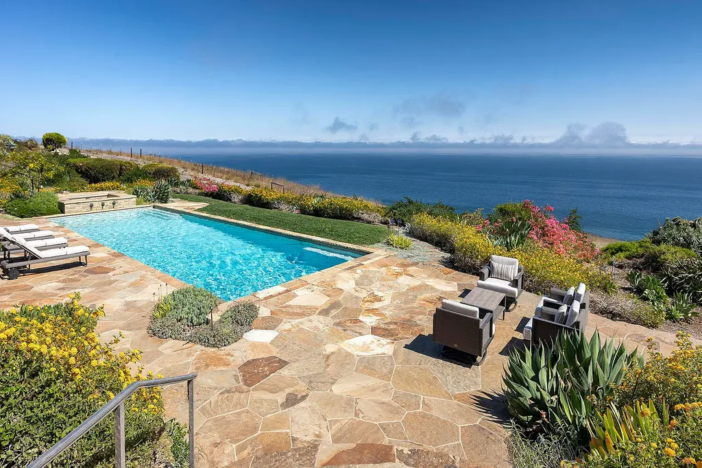 13600 Calle Real Home in Goleta, California. Escape to the enchanting Villa Del Mare, a blend of Old California charm and modern luxury on 287 acres near Refugio State Beach. With panoramic views of the coastline and foothills, this one-level estate offers 5 en suite bedrooms, spacious entertainment areas, a private helipad, and sustainable features like solar power and private water sources.