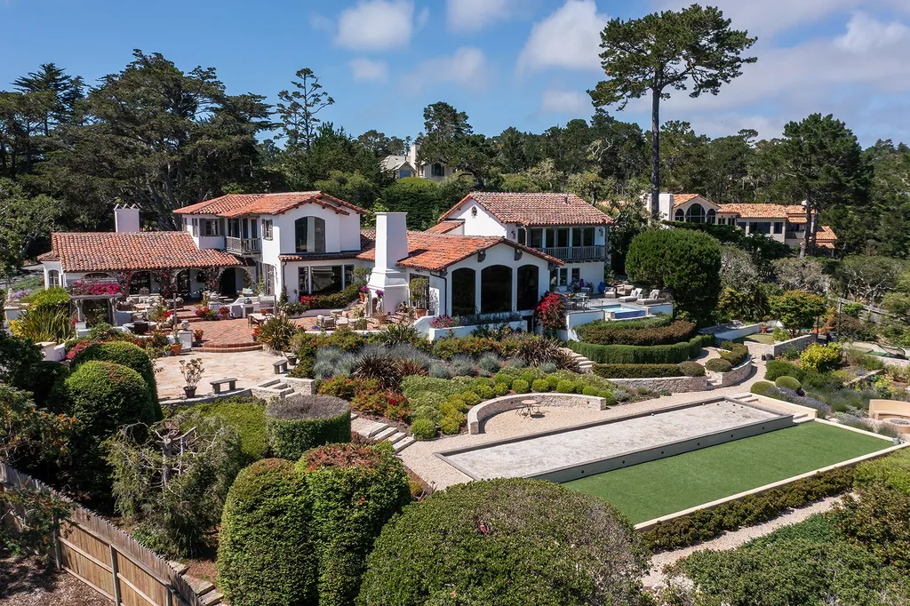 1463 Oleada Road Home in Pebble Beach, California. Explore the timeless elegance of Bella Vista, an original Pebble Beach estate nestled atop Strawberry Hill. This gated 2.6-acre haven offers panoramic views, lush gardens, and modern amenities. With a renovated 8,500+ sq ft main house, a guest house, and a studio carriage house, this Spanish-style compound showcases extraordinary entertaining spaces, outdoor fireplaces, a sport court, and more. Indulge in gourmet living with a chef's kitchen, wine cellar, and billiards room. 