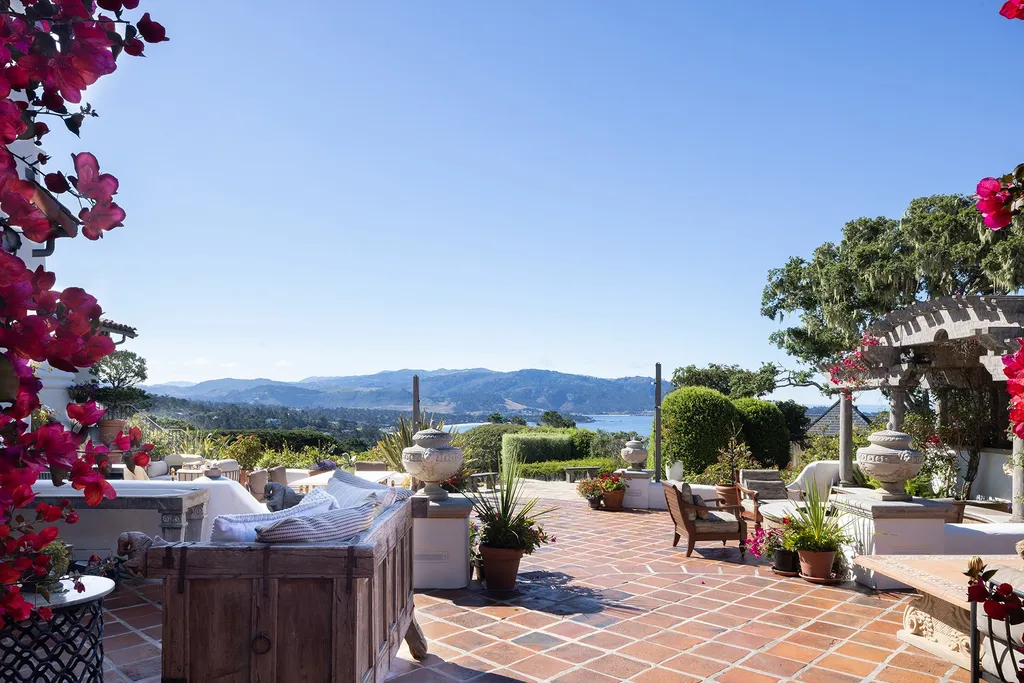 1463 Oleada Road Home in Pebble Beach, California. Explore the timeless elegance of Bella Vista, an original Pebble Beach estate nestled atop Strawberry Hill. This gated 2.6-acre haven offers panoramic views, lush gardens, and modern amenities. With a renovated 8,500+ sq ft main house, a guest house, and a studio carriage house, this Spanish-style compound showcases extraordinary entertaining spaces, outdoor fireplaces, a sport court, and more. Indulge in gourmet living with a chef's kitchen, wine cellar, and billiards room. 