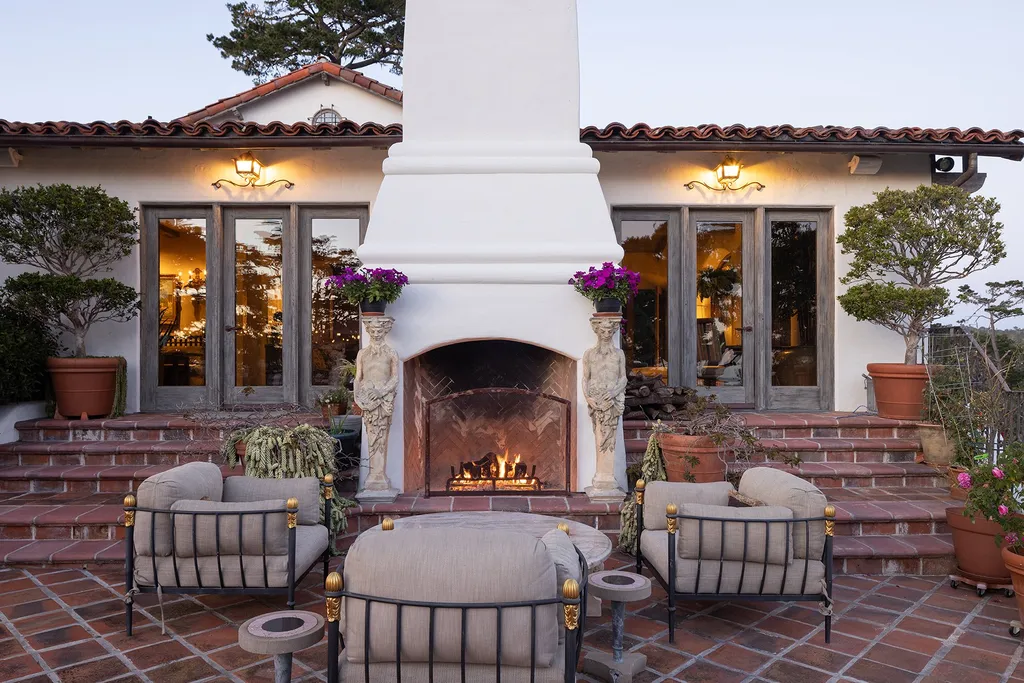 1463 Oleada Road Home in Pebble Beach, California. Explore the timeless elegance of Bella Vista, an original Pebble Beach estate nestled atop Strawberry Hill. This gated 2.6-acre haven offers panoramic views, lush gardens, and modern amenities. With a renovated 8,500+ sq ft main house, a guest house, and a studio carriage house, this Spanish-style compound showcases extraordinary entertaining spaces, outdoor fireplaces, a sport court, and more. Indulge in gourmet living with a chef's kitchen, wine cellar, and billiards room. 