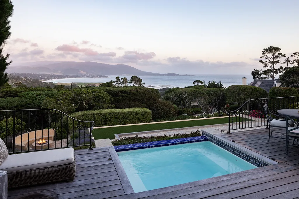 1463 Oleada Road Home in Pebble Beach, California. Explore the timeless elegance of Bella Vista, an original Pebble Beach estate nestled atop Strawberry Hill. This gated 2.6-acre haven offers panoramic views, lush gardens, and modern amenities. With a renovated 8,500+ sq ft main house, a guest house, and a studio carriage house, this Spanish-style compound showcases extraordinary entertaining spaces, outdoor fireplaces, a sport court, and more. Indulge in gourmet living with a chef's kitchen, wine cellar, and billiards room. 