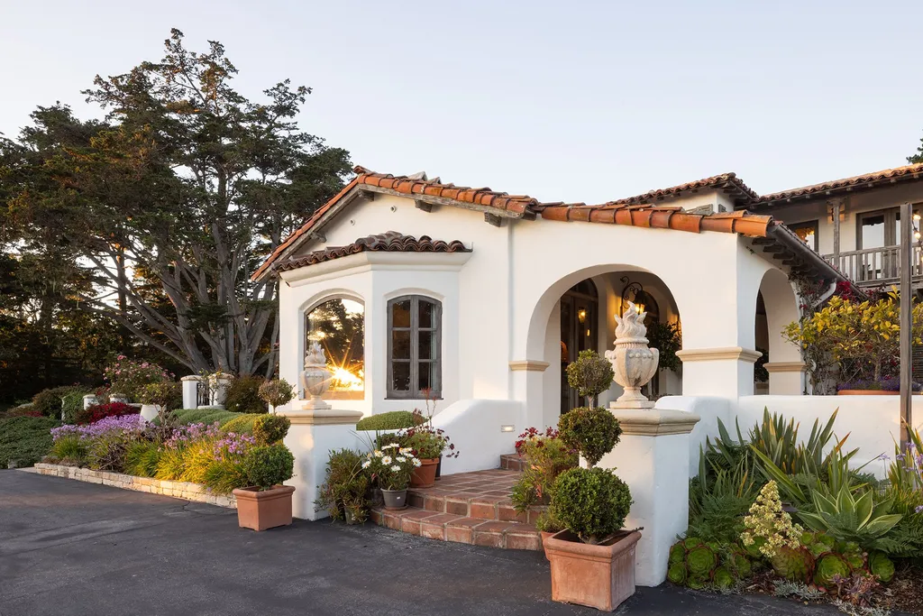 1463 Oleada Road Home in Pebble Beach, California. Explore the timeless elegance of Bella Vista, an original Pebble Beach estate nestled atop Strawberry Hill. This gated 2.6-acre haven offers panoramic views, lush gardens, and modern amenities. With a renovated 8,500+ sq ft main house, a guest house, and a studio carriage house, this Spanish-style compound showcases extraordinary entertaining spaces, outdoor fireplaces, a sport court, and more. Indulge in gourmet living with a chef's kitchen, wine cellar, and billiards room. 