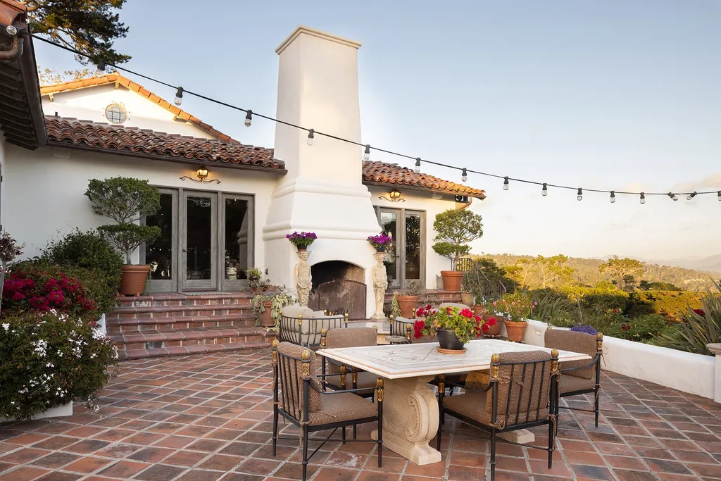1463 Oleada Road Home in Pebble Beach, California. Explore the timeless elegance of Bella Vista, an original Pebble Beach estate nestled atop Strawberry Hill. This gated 2.6-acre haven offers panoramic views, lush gardens, and modern amenities. With a renovated 8,500+ sq ft main house, a guest house, and a studio carriage house, this Spanish-style compound showcases extraordinary entertaining spaces, outdoor fireplaces, a sport court, and more. Indulge in gourmet living with a chef's kitchen, wine cellar, and billiards room. 