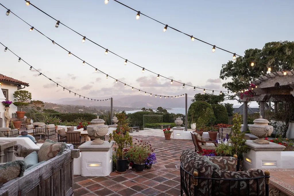 1463 Oleada Road Home in Pebble Beach, California. Explore the timeless elegance of Bella Vista, an original Pebble Beach estate nestled atop Strawberry Hill. This gated 2.6-acre haven offers panoramic views, lush gardens, and modern amenities. With a renovated 8,500+ sq ft main house, a guest house, and a studio carriage house, this Spanish-style compound showcases extraordinary entertaining spaces, outdoor fireplaces, a sport court, and more. Indulge in gourmet living with a chef's kitchen, wine cellar, and billiards room. 