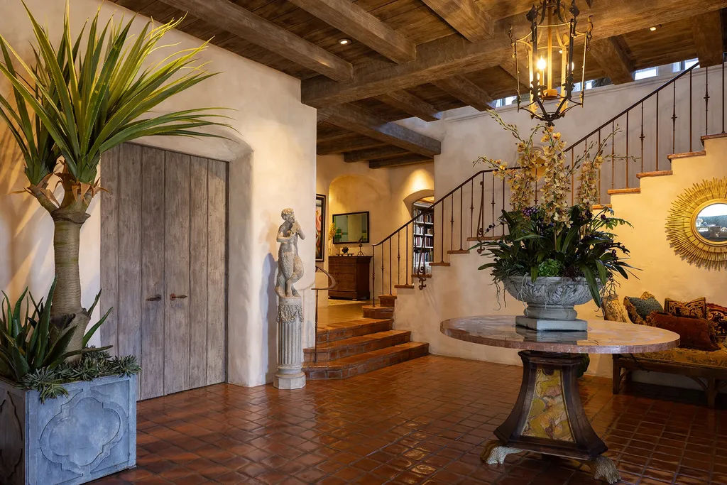 1463 Oleada Road Home in Pebble Beach, California. Explore the timeless elegance of Bella Vista, an original Pebble Beach estate nestled atop Strawberry Hill. This gated 2.6-acre haven offers panoramic views, lush gardens, and modern amenities. With a renovated 8,500+ sq ft main house, a guest house, and a studio carriage house, this Spanish-style compound showcases extraordinary entertaining spaces, outdoor fireplaces, a sport court, and more. Indulge in gourmet living with a chef's kitchen, wine cellar, and billiards room. 