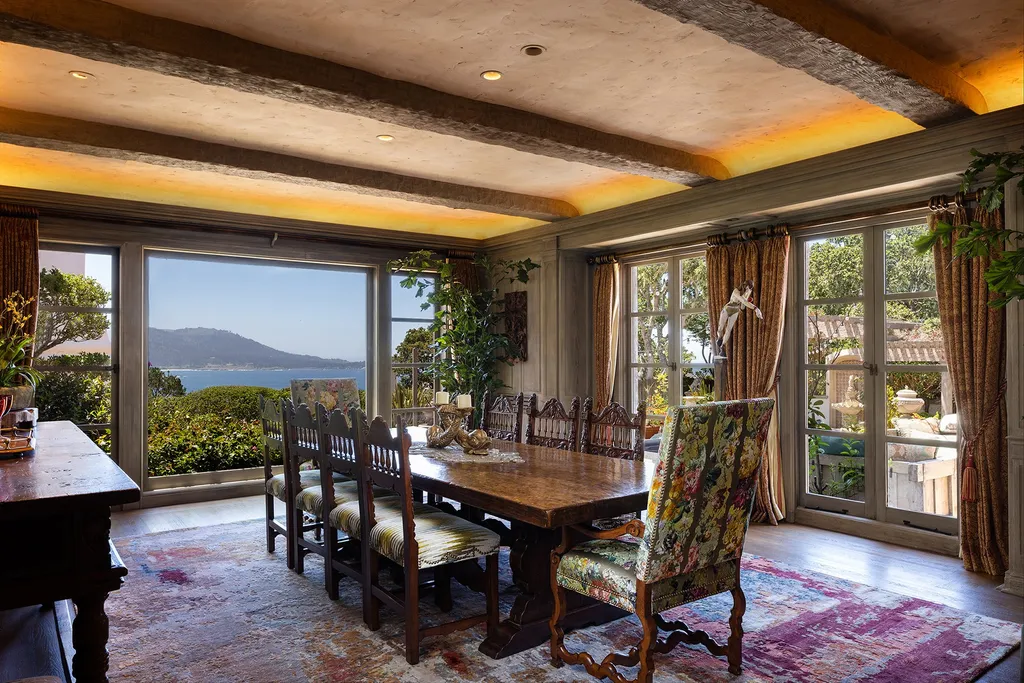 1463 Oleada Road Home in Pebble Beach, California. Explore the timeless elegance of Bella Vista, an original Pebble Beach estate nestled atop Strawberry Hill. This gated 2.6-acre haven offers panoramic views, lush gardens, and modern amenities. With a renovated 8,500+ sq ft main house, a guest house, and a studio carriage house, this Spanish-style compound showcases extraordinary entertaining spaces, outdoor fireplaces, a sport court, and more. Indulge in gourmet living with a chef's kitchen, wine cellar, and billiards room. 
