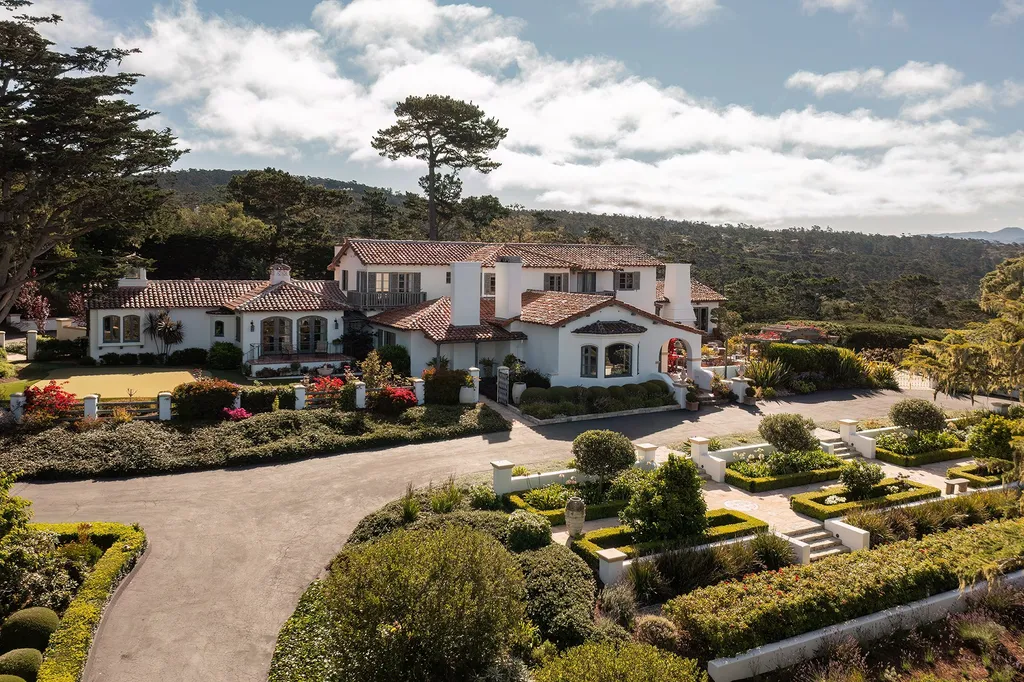 1463 Oleada Road Home in Pebble Beach, California. Explore the timeless elegance of Bella Vista, an original Pebble Beach estate nestled atop Strawberry Hill. This gated 2.6-acre haven offers panoramic views, lush gardens, and modern amenities. With a renovated 8,500+ sq ft main house, a guest house, and a studio carriage house, this Spanish-style compound showcases extraordinary entertaining spaces, outdoor fireplaces, a sport court, and more. Indulge in gourmet living with a chef's kitchen, wine cellar, and billiards room. 