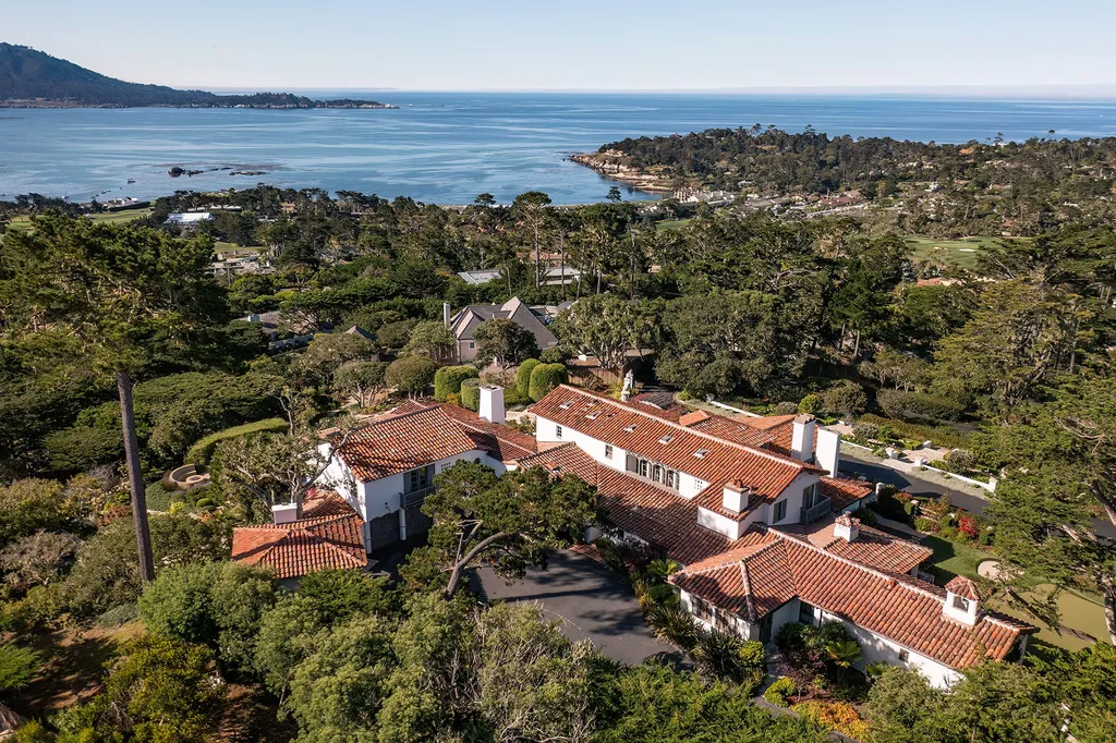 1463 Oleada Road Home in Pebble Beach, California. Explore the timeless elegance of Bella Vista, an original Pebble Beach estate nestled atop Strawberry Hill. This gated 2.6-acre haven offers panoramic views, lush gardens, and modern amenities. With a renovated 8,500+ sq ft main house, a guest house, and a studio carriage house, this Spanish-style compound showcases extraordinary entertaining spaces, outdoor fireplaces, a sport court, and more. Indulge in gourmet living with a chef's kitchen, wine cellar, and billiards room. 