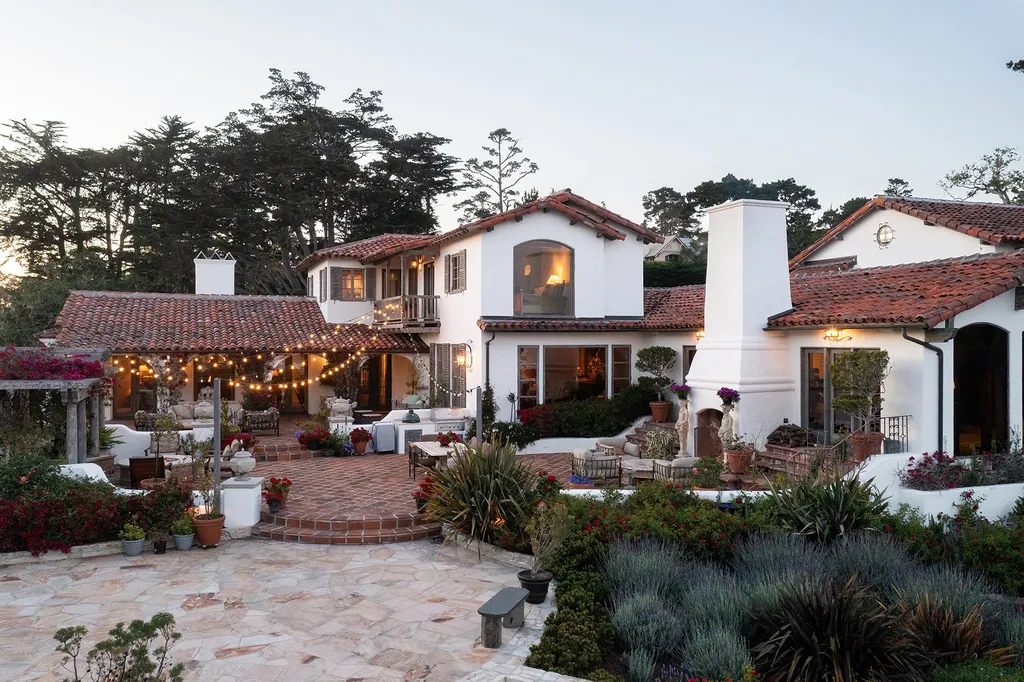 1463 Oleada Road Home in Pebble Beach, California. Explore the timeless elegance of Bella Vista, an original Pebble Beach estate nestled atop Strawberry Hill. This gated 2.6-acre haven offers panoramic views, lush gardens, and modern amenities. With a renovated 8,500+ sq ft main house, a guest house, and a studio carriage house, this Spanish-style compound showcases extraordinary entertaining spaces, outdoor fireplaces, a sport court, and more. Indulge in gourmet living with a chef's kitchen, wine cellar, and billiards room. 