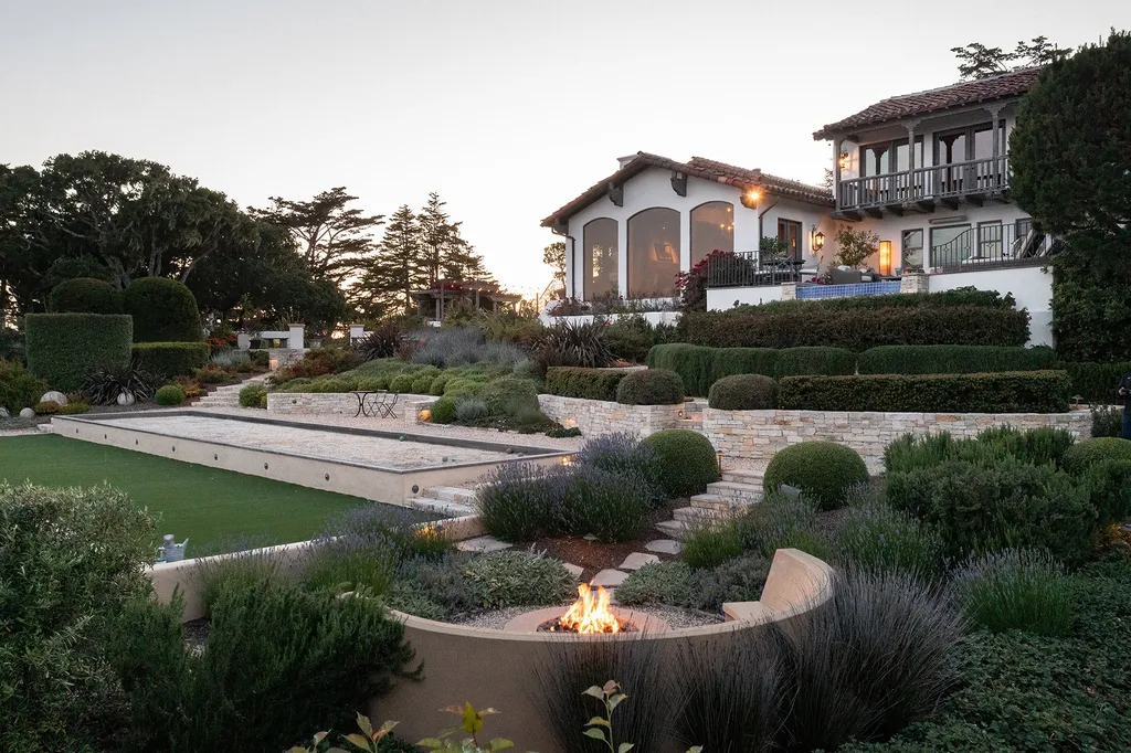 1463 Oleada Road Home in Pebble Beach, California. Explore the timeless elegance of Bella Vista, an original Pebble Beach estate nestled atop Strawberry Hill. This gated 2.6-acre haven offers panoramic views, lush gardens, and modern amenities. With a renovated 8,500+ sq ft main house, a guest house, and a studio carriage house, this Spanish-style compound showcases extraordinary entertaining spaces, outdoor fireplaces, a sport court, and more. Indulge in gourmet living with a chef's kitchen, wine cellar, and billiards room. 