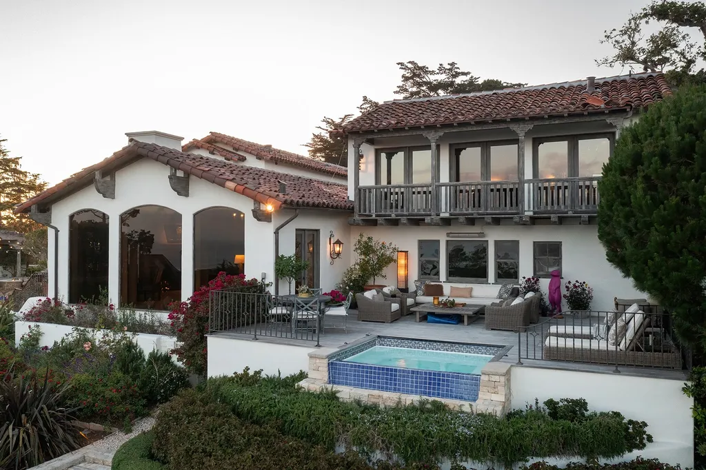 1463 Oleada Road Home in Pebble Beach, California. Explore the timeless elegance of Bella Vista, an original Pebble Beach estate nestled atop Strawberry Hill. This gated 2.6-acre haven offers panoramic views, lush gardens, and modern amenities. With a renovated 8,500+ sq ft main house, a guest house, and a studio carriage house, this Spanish-style compound showcases extraordinary entertaining spaces, outdoor fireplaces, a sport court, and more. Indulge in gourmet living with a chef's kitchen, wine cellar, and billiards room. 