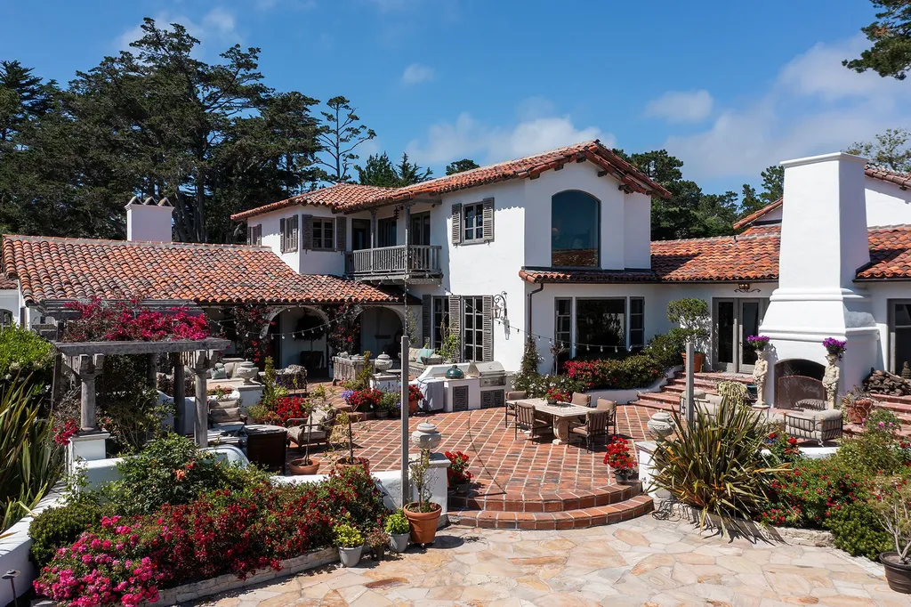 1463 Oleada Road Home in Pebble Beach, California. Explore the timeless elegance of Bella Vista, an original Pebble Beach estate nestled atop Strawberry Hill. This gated 2.6-acre haven offers panoramic views, lush gardens, and modern amenities. With a renovated 8,500+ sq ft main house, a guest house, and a studio carriage house, this Spanish-style compound showcases extraordinary entertaining spaces, outdoor fireplaces, a sport court, and more. Indulge in gourmet living with a chef's kitchen, wine cellar, and billiards room. 